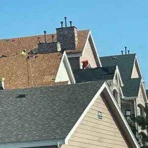 Roofers working on a condo complex under repair, illustrating the type of property covered by HO6 condo insurance by Elite Roofing & Solar