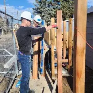 Elite Roofing & Solar team Volunteers holding a plank for Habitat for Humanity in Denver