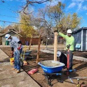 Elite Roofing & Solar team Volunteers in a process of pouring a cement in Denver