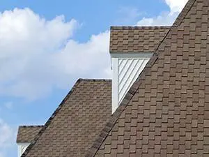 new roof with brown shingles by Elite Roofing.