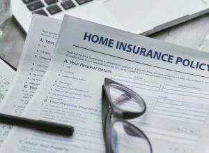 closeup of homeowners insurance policy documents that likely cover roof damage at Elite Roofing & Solar in Denver, CO