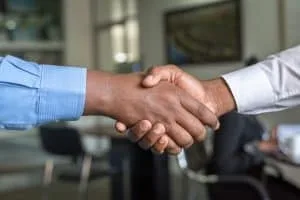 Two men shaking hands agreeing to do business with Elite Roofing.