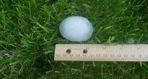 Hailstone from powerful hail storms next to ruler